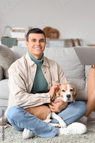 Young man with cute Beagle ...