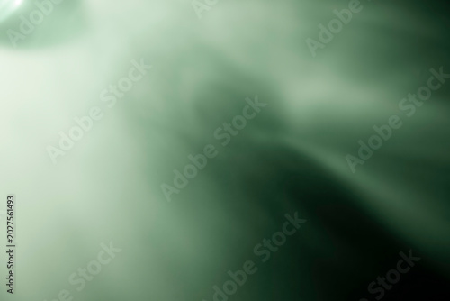 Abstract green light leak effect on dark background for overlay