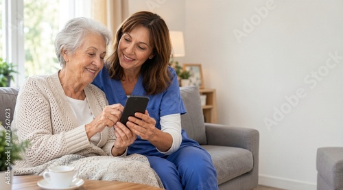 Smiling nurse showing smartphone to senior woman
