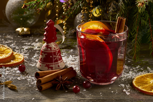 Cozy winter beverage presentation. Inviting holiday scene featuring spiced wine and seasonal decorations