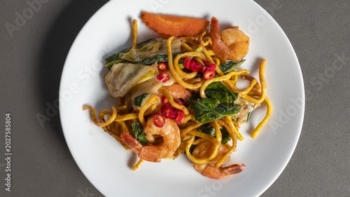 Rotating Plate of Delcious Spicy Thai Noodles with Prawns 