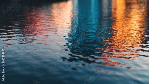 City Lights Reflecting on Water Surface at Dusk