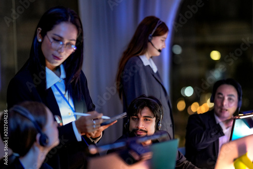 Fotografija Professional businesswoman holding tablet and stylus assisting IT support agents