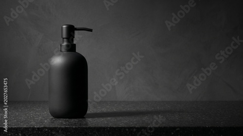 Matte Black Soap Dispenser on Dark Countertop with Copy Space