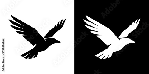 Tableau sur toile Birds depicted in contrasting black and white silhouettes fly side by side