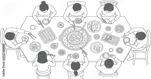Overhead view of diverse group of people enjoying a communal meal together around a large table