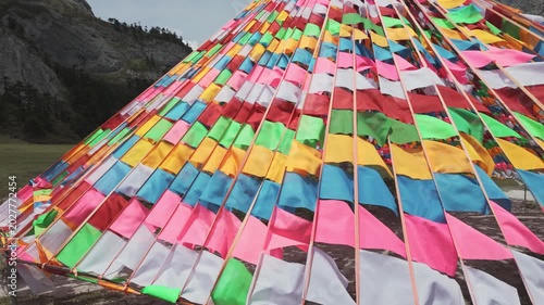 Geometric arrangement of multicolored prayer flags in Balagezong mountain landscape