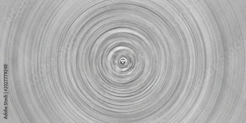 Abstract monochrome grey and white spiraling concentric circles with subtle noise texture in a minimalist design.