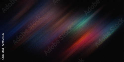 Abstract streaks of color blur and motion with noise effect on dark background creating dynamic energy and visual flow.
