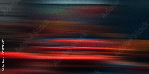 Abstract streaks of light and color with motion blur and a dark, grainy background effect.