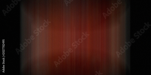 Abstract vertical motion blur of deep red and orange tones with dark borders, creating a dramatic textured background.