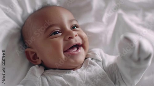 Infant Smiling Baby Lying Comfortably in Soft Light Setting