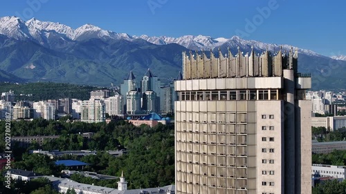 A quadcopter aerial view of the central part of Almaty, Kazakhstan, on a spring morning, with a mountain range in the background.