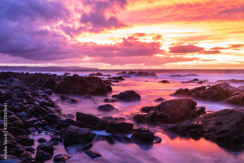 Fototapeta premium Colorful sunset over rocky coastline at Carrickalinga South Australia