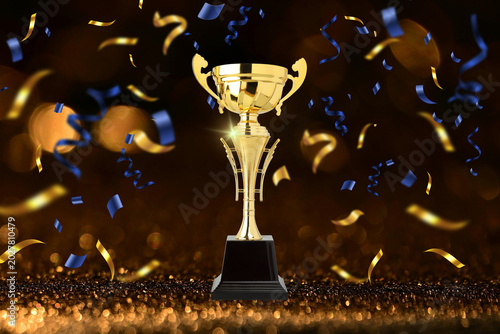 Foto Golden trophy stands tall with colorful confetti around it