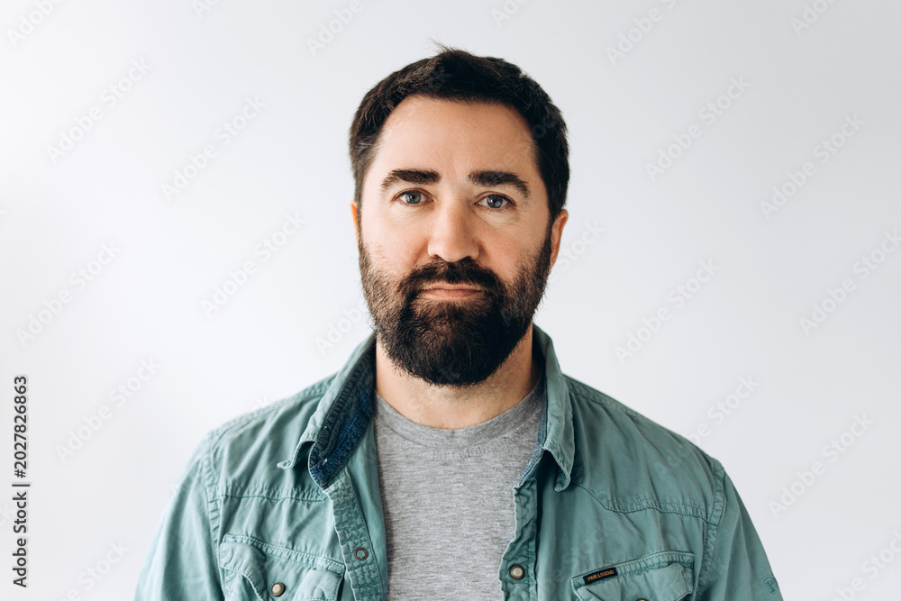 Obraz premium Serious bearded Latin man wearing stylish casual clothes confident and happy looking at camera
