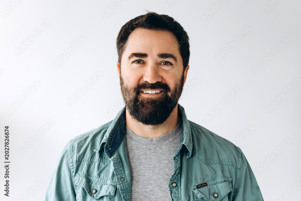 Obraz premium Smiling bearded Latin man wearing stylish casual clothes confident and happy looking at camera