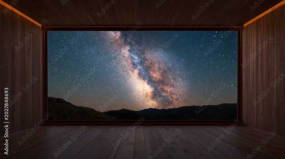 Obraz premium Milky way night sky visible through large window in modern wooden room, serene and dramatic