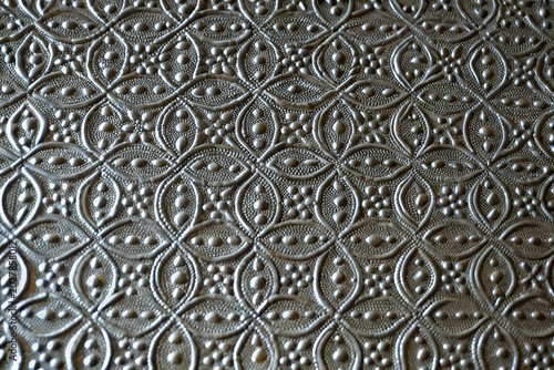 Photos antiqued pewter metal texture background with geometric embossed floral pattern