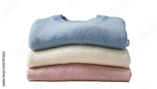 Canvastavla Stack of three folded sweaters in blue cream and pink, isolated on transparent b