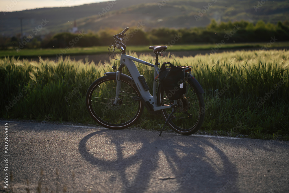 Fototapeta premium Bicycle in sunset on a rural road.