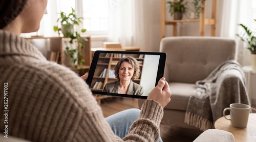 Over the shoulder view of patient in online telehealth therapy session