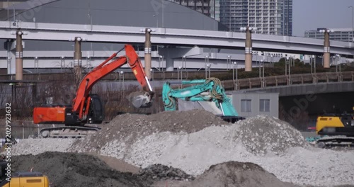 Moving cranes at the under construction in Tokyo in winter telephoto shot