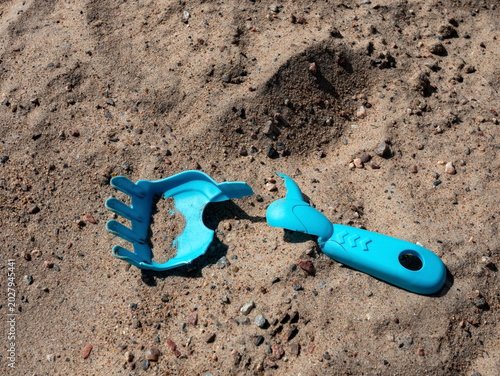 children's broken blue plastic toy in the sandbox