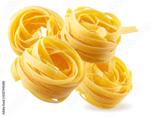 Fresh Yellow Tagliatelle Pasta Nests Arranged on White Background