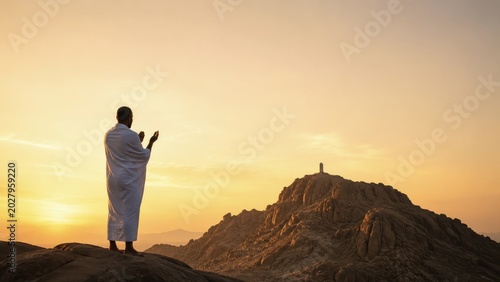 Muslim Pilgrim Praying at Mount Arafat During Hajj Sunset Pilgrimage