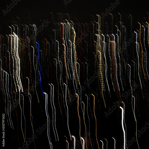 fuzzy long traces of city lights in dark night