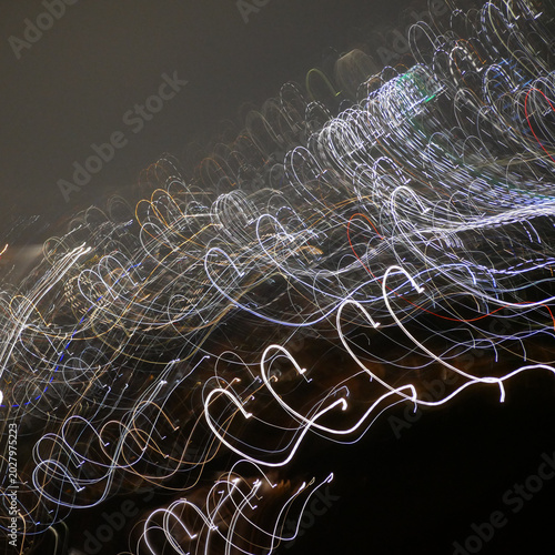 fuzzy spiral traces of city lights in dark night