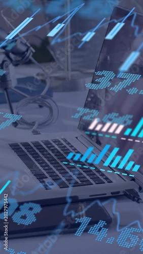 Vertical video: Data feed driving overlay, laptop centered while charts pulsing for market updates