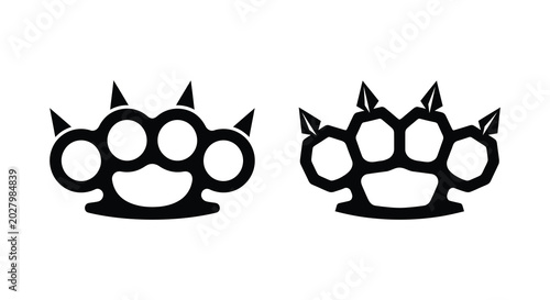 Photos Black brass knuckles silhouette with four finger holes and spikes isolated on wh