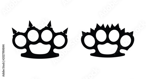 Photos Two brass knuckles with finger holes black silhouette on a white background