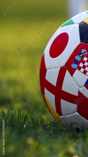 International soccer ball on grass at sunset