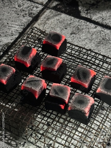 Fire burning from coconut charcoal briquette for business production	
