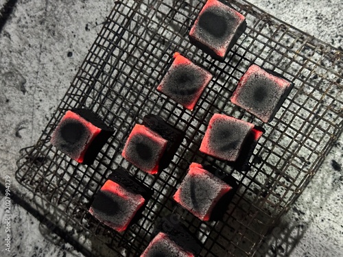 Fire burning from coconut charcoal briquette for business production	
