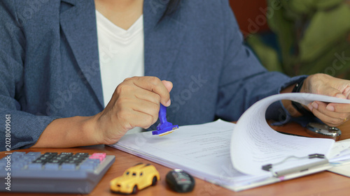 Obraz na plátně Business professional stamping approval documents at office desk with calculator