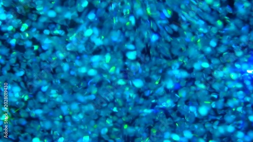 holographic Iridescent glitter particles background, showcasing a distinct shimmering texture with rainbow-colored light