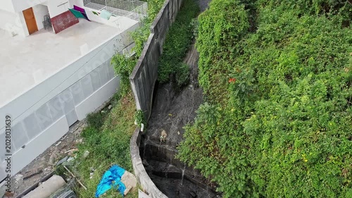 Aerial View shows Drainage canal Filled with Water Amid Lush Green Foliage