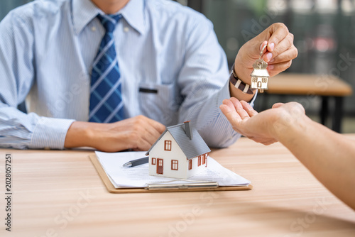Real estate transaction office business meeting professional setting close-up property ownership transfer