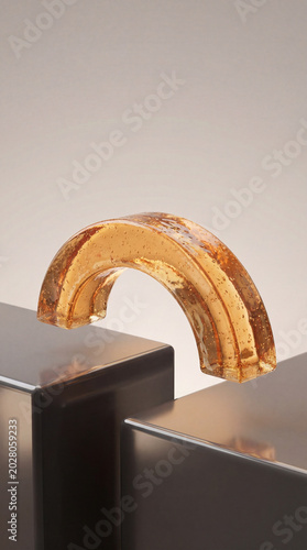 Abstract Amber Glass Arch on Geometric Metallic Blocks