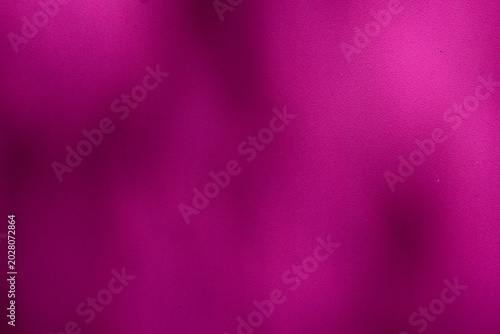 Abstract vibrant magenta background with subtle shadows and texture.