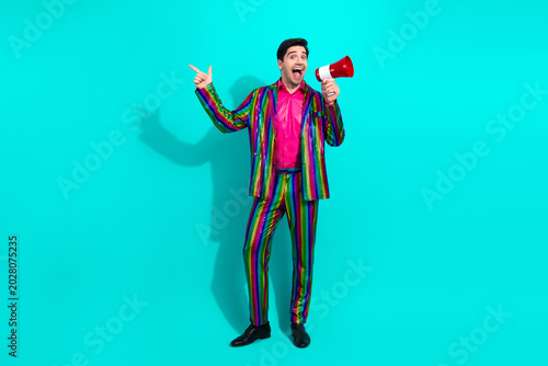 Konstfotografi Vibrant retro showman in rainbow suit with megaphone inviting a party audience a