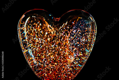 Obraz na płótnie a heart-shaped glass paperweight filled with holographic Iridescent glitter part
