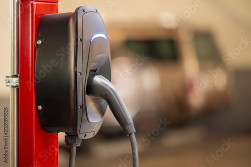 EV charging and electric car, Electric car charging station for charge EV battery, Plug for vehicle with electric engine, EV charger clean energy, Charging point at car parking lot.