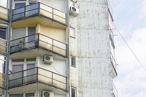 Photos Close-up of facade section on aging Yugoslav-era apartment block with triangular balconies forming repetitive architectural rhythm