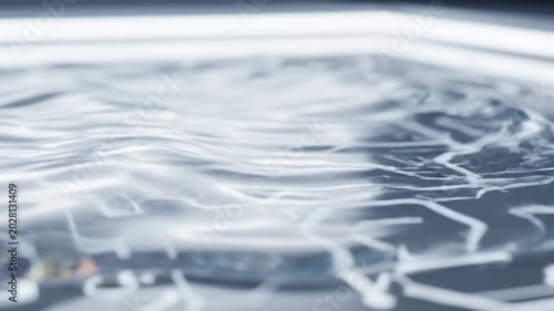 Abstract Water Droplet Forming on Futuristic Circuit Board with Slow Motion Liquid Dynamics