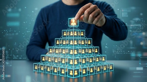 Human Resources Management: Hand placing top person in a digital pyramid representing company hierarchy, teamwork, and organizational structure.